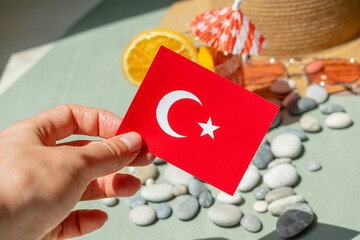 Turkey flag in a female hand. Tourism to Turkey. Vacation in Turkey