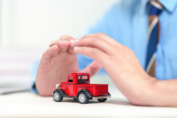 Fototapeta premium Car protected by hands - Concept of auto insurance