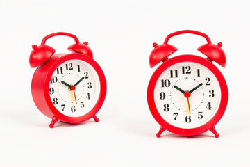 red analog alarm clock on white background