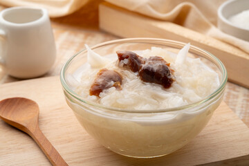 Sweet Sticky Rice with dry Longan and sliced young Coconut topping with coconut cream ,Khao niew piak lam yai (Thai Dessert)