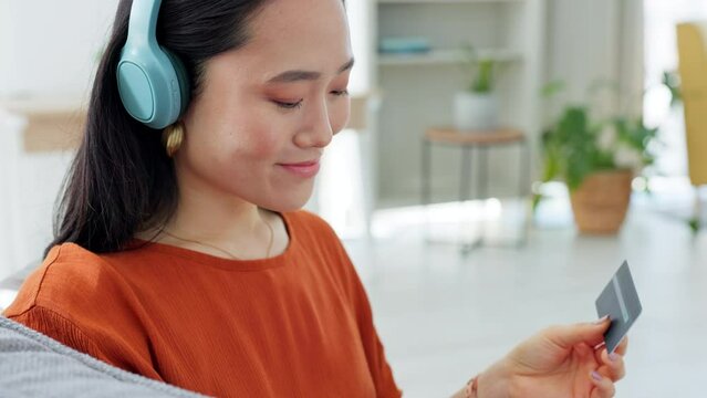 Credit card, headphones and laptop of woman with music premium, subscription payment or online shopping on ecommerce fintech. Girl on home sofa with audio website discount or internet finance banking