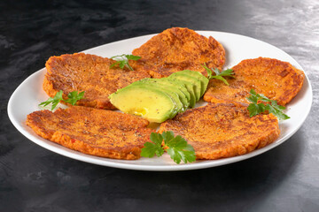 Korean kimchi vegetable fritters with grated carrots and avocados. Diet snack. Pancakes with kimchi.