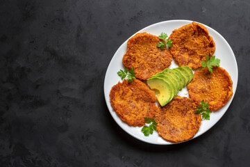 Korean kimchi vegetable fritters with grated carrots and avocados. Diet snack. Pancakes with kimchi.