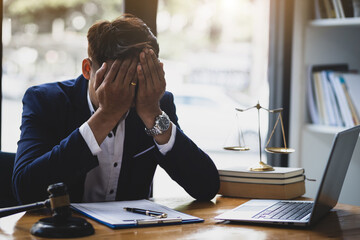 A lawyer or businessman is stressed about losing a lawsuit and going bankrupt.