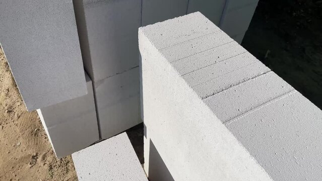 The gas block is at a construction site. Slow motion video with gas block pallet