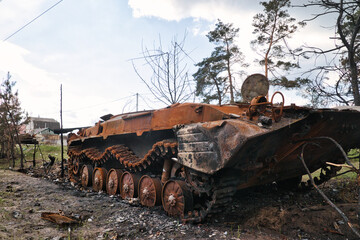 A burnt armored personnel carrier of russians in a village near Kyiv