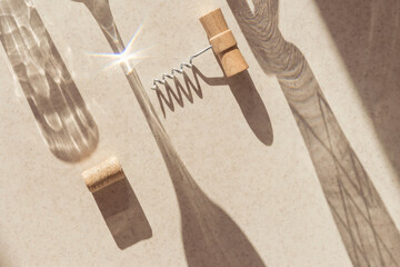 Creative composition made of corkscrew and cork of wine on pastel background with sunlit and...