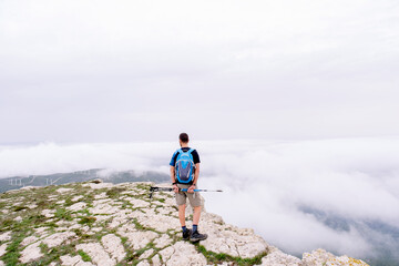 Obraz premium Man equipped with sticks trekking alone in the mountains.
