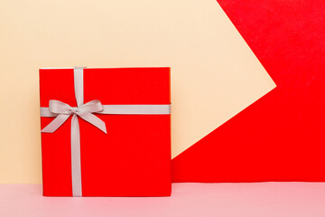 holiday handmade present tied gray ribbon bow top view with copy space. Flat lay holiday background. Birthday or christmas present. Christmas gift box concept with copy space