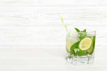 Mojito cocktail. Refreshing mojito cocktail with lime, lemon and mint in a tall glass with a stick
