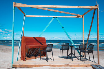 beach chairs, umbrellas and piano