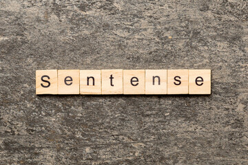Fototapeta premium Sentence word written on wood block. Sentence text on table, concept