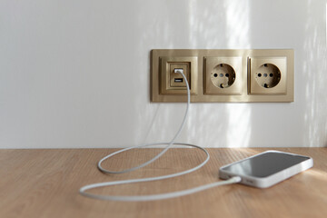 usb charger with phone. The phone is charged from the usb in the wall.