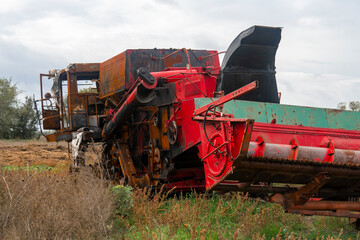 War in Ukraine. 2022 Russian invasion of Ukraine. Countryside. A destroyed burnt harvester stands...