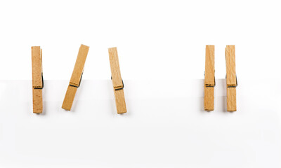 five wooden clothespins on a rope isolated on white