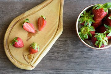 strawberries in a bowl and a wooden table