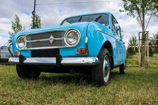 Classic bright blue Renault 4 L car on a field