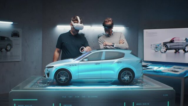Two development engineers in the studio are designing an eco-friendly sustainable standard electric vehicle using 3D modeling technology and VR headsset. 3D interface of diagnostic application.
