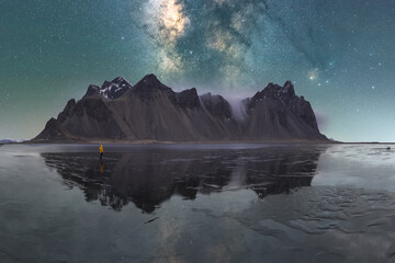 Picturesque scenery of sea and mountains on bright starry sky in dusk