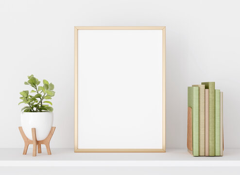 Interior poster mockup with vertical golden metal frame on white wall decorated with plant in vase  and books. A4, A3 size format. 3D rendering, illustration.