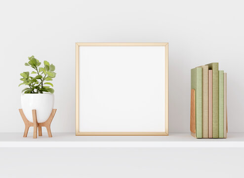 Interior poster mockup with square golden metal frame on white wall decorated with plant in vase  and books. A4, A3 size format. 3D rendering, illustration.