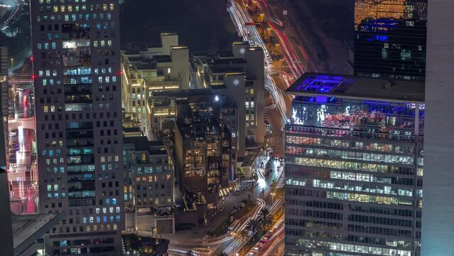 Office skyscrapers in financial district aerial day to night transition timelapse. Top view to hotels and traffic on a road from above after sunset