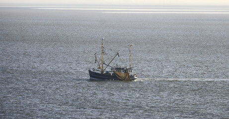Elbe river, Germany - 10 22 2022: Fishing vessel while engaged in fishing on Elbe river in Germany