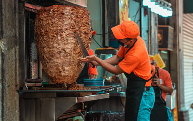 Mexican taquero working doing tacos	
