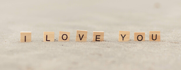 I love you word Written With Blocks On sand