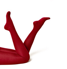  Women's female legs in red tights. Children's legs in red cotton tights. On a white background.