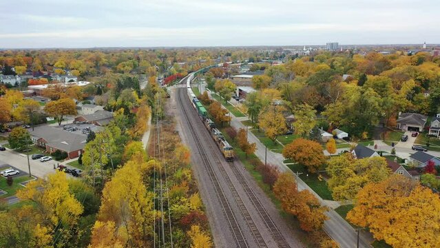 Aerial video of train, downtown Wheaton, Illinois. USA