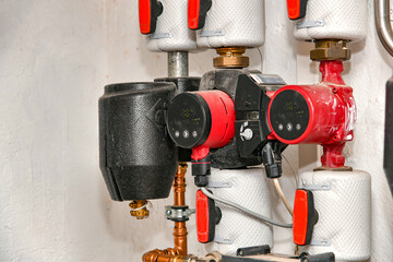 Hot water control system with hydraulic pumps in a private house with autonomous heating.