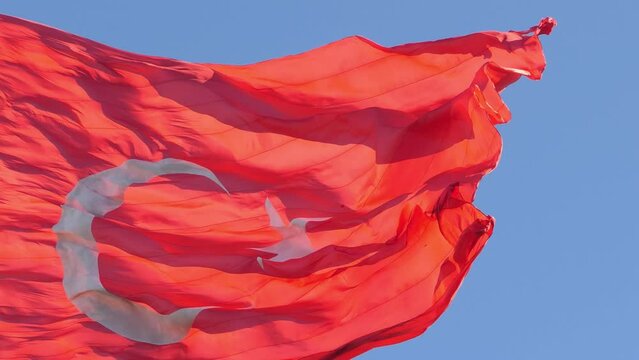 Flag Of Turkey Fluttering In The Wind 4K. T&uuml;rkiye flag waving in slow motion in the wind over blue sky 4k