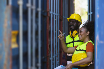 African American couple customs team staff worker working together with check list shipping order at port container yard enjoy work happy smile