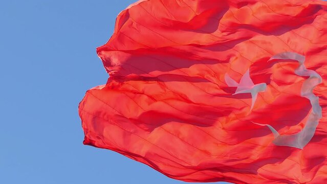 Flag Of Turkey Fluttering In The Wind 4K. T&uuml;rkiye flag waving in slow motion in the wind over blue sky 4k