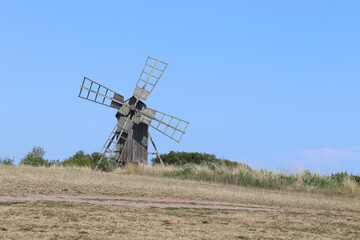 Fototapeta premium Typical old historic style windmill, found on the island of Öland in Sweden. Against a clear blue sky with copy space.