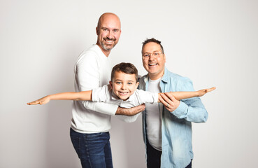 Two man couple with adopted child on white background