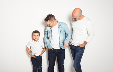 Two man couple with adopted child on white background