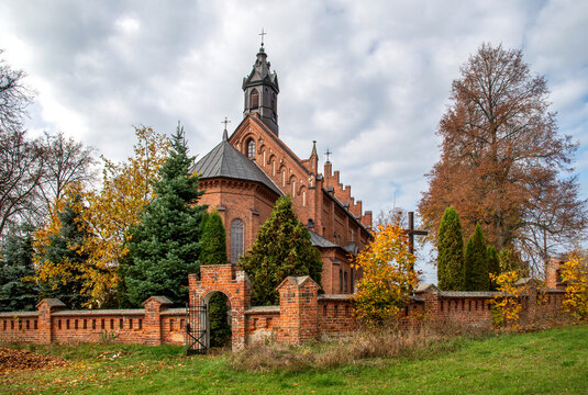 General view and architectural details of the brick belfry built in 1875 and the Catholic Church of the Immaculate Conception of the Blessed Virgin Mary in Ceranów in Mazovia, Poland.