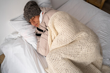 Energy crisis in Europe. A man freezes sleeping in bedroom. Increase in the price of natural gas...