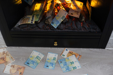 Money burns. Euro banknotes burning in flames