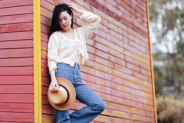 Candid lifestyle Portrait of happy young beautiful asian sexy woman enjoying life outdoor at spring. Smiling millennial girl with perfect clear glow skin and long brunette hair