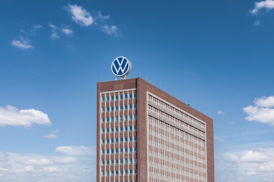 Volkswagen headquarters building with VW logo on top at the Volkswagen car plant in Wolfsburg, Germany - March 2022
