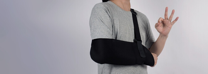Broken arm. Arm Sling therapy support and covered around elbow first knuckle broken arm. Post...