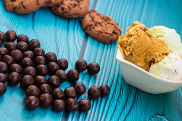 Ice cream cones with colorful candies, cookies, and chocolate balls