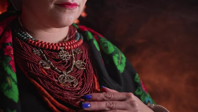 Demonstrating traditional antique jewelry necklace. National costume of Ukraine. Ukrainian woman in legacy ancient coral beads, Zgarda - archaic hutsul neck ornament of status religious purpose