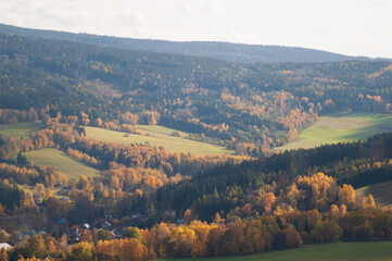 Fototapeta na wymiar beautiful autumn landscape. view from the mountain to the green fields, trees. tranquility and nature