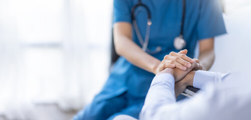 Cropped shot of a female nurse hold her senior patient's hand. Giving Support. Doctor helping old...