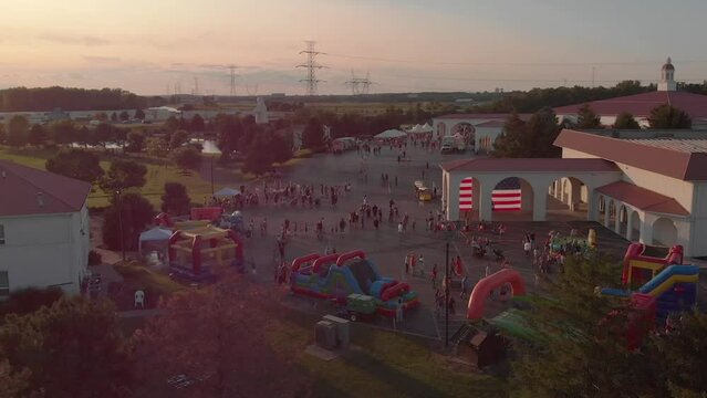 Aerial drone footage of people walking around the Solid Rock Church at sunset in Monroe, Ohio