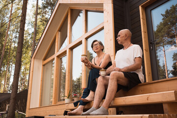 people drinking coffee on terrace of country house